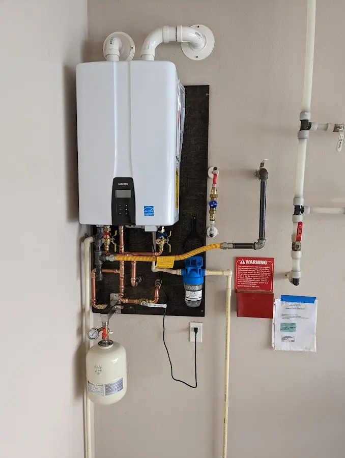 Professional plumber installing copper piping in a Dingman home